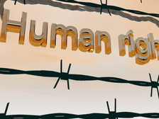 Tekst 'Human rights' achter prikkeldraad